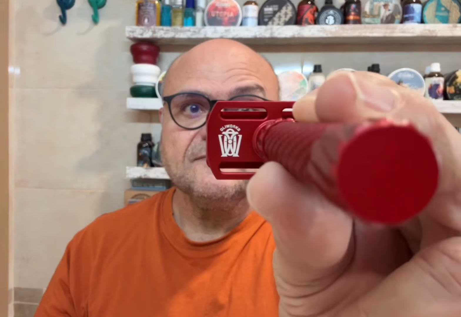 A finished OliWorks razor in hand at the Mesa workshop.